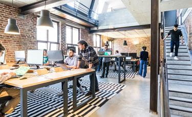 flexible workspace people working in converted warehouse